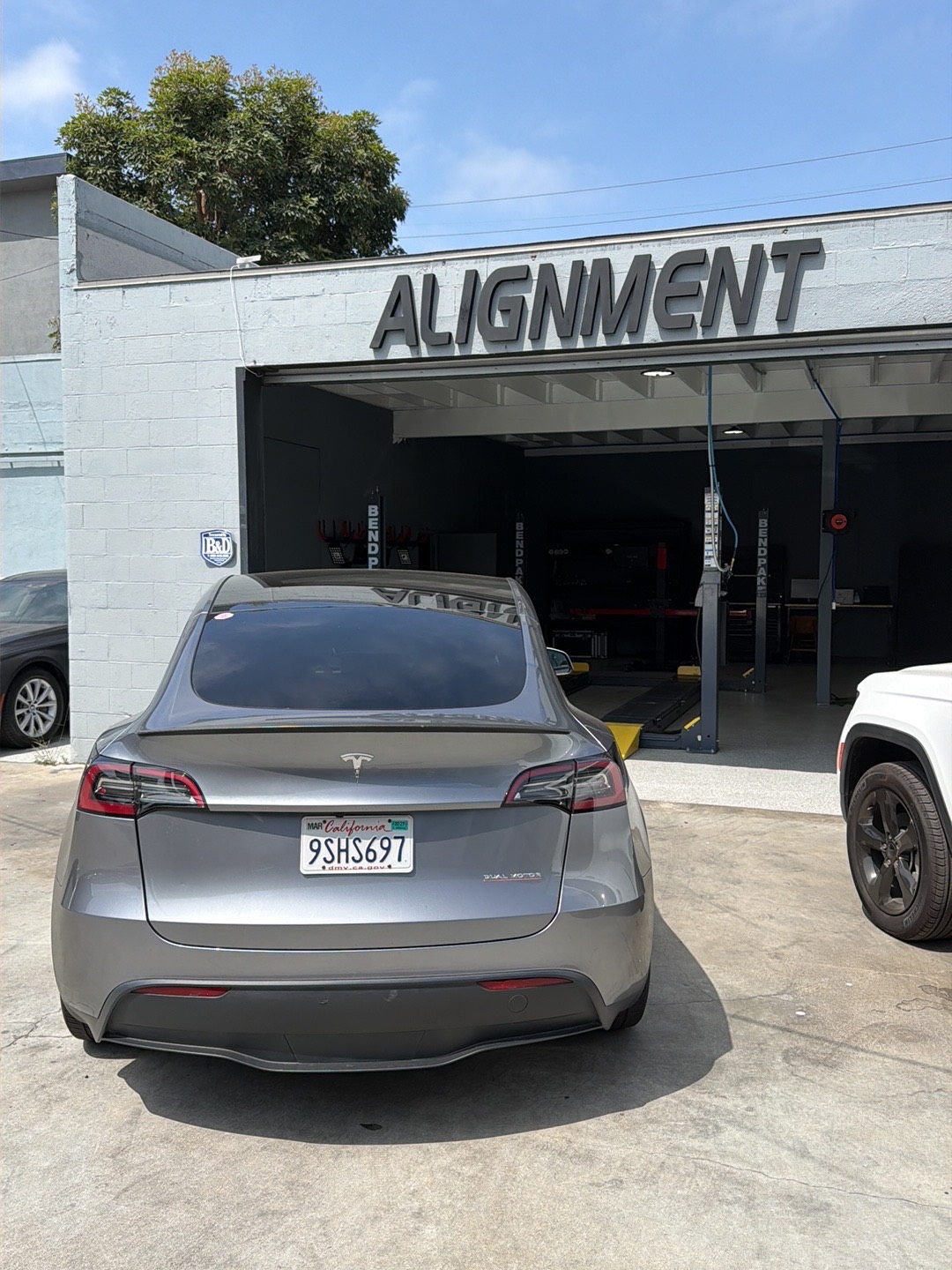 Tesla Model Y outside the dedicated Calibri Motorsport alignment bay in Hawthorne