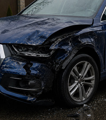 Audi with visible front-left collision damage in a supplied before photograph