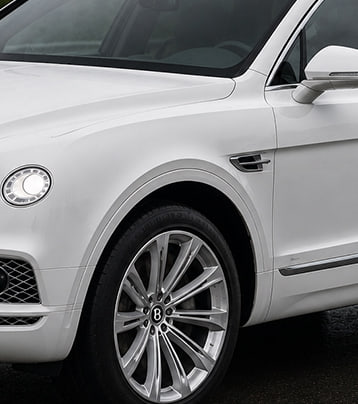 White Bentley SUV front-left exterior in the supplied after-work photograph