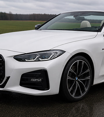 White BMW front exterior in the supplied paired later photograph