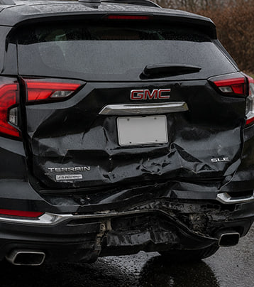 GMC with visible rear collision damage in a supplied before photograph