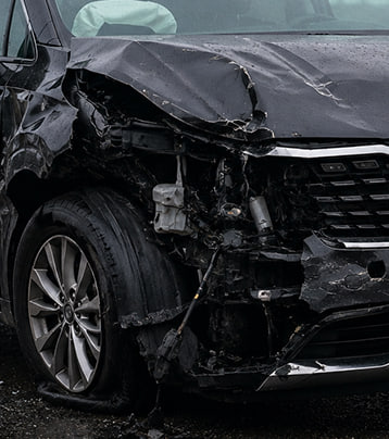 Kia with visible front-left collision damage in a supplied before photograph