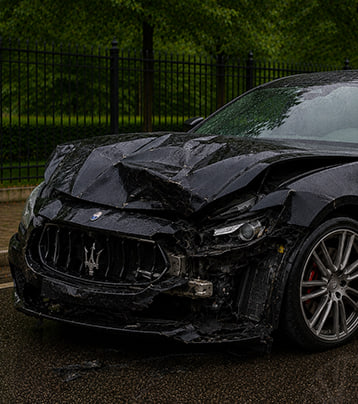 Maserati with visible front collision damage in a supplied before photograph