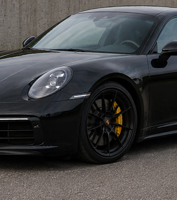 Black Porsche front-left exterior in the supplied after-work photograph