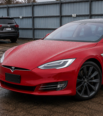 Red Tesla front-left exterior in the supplied after-work photograph