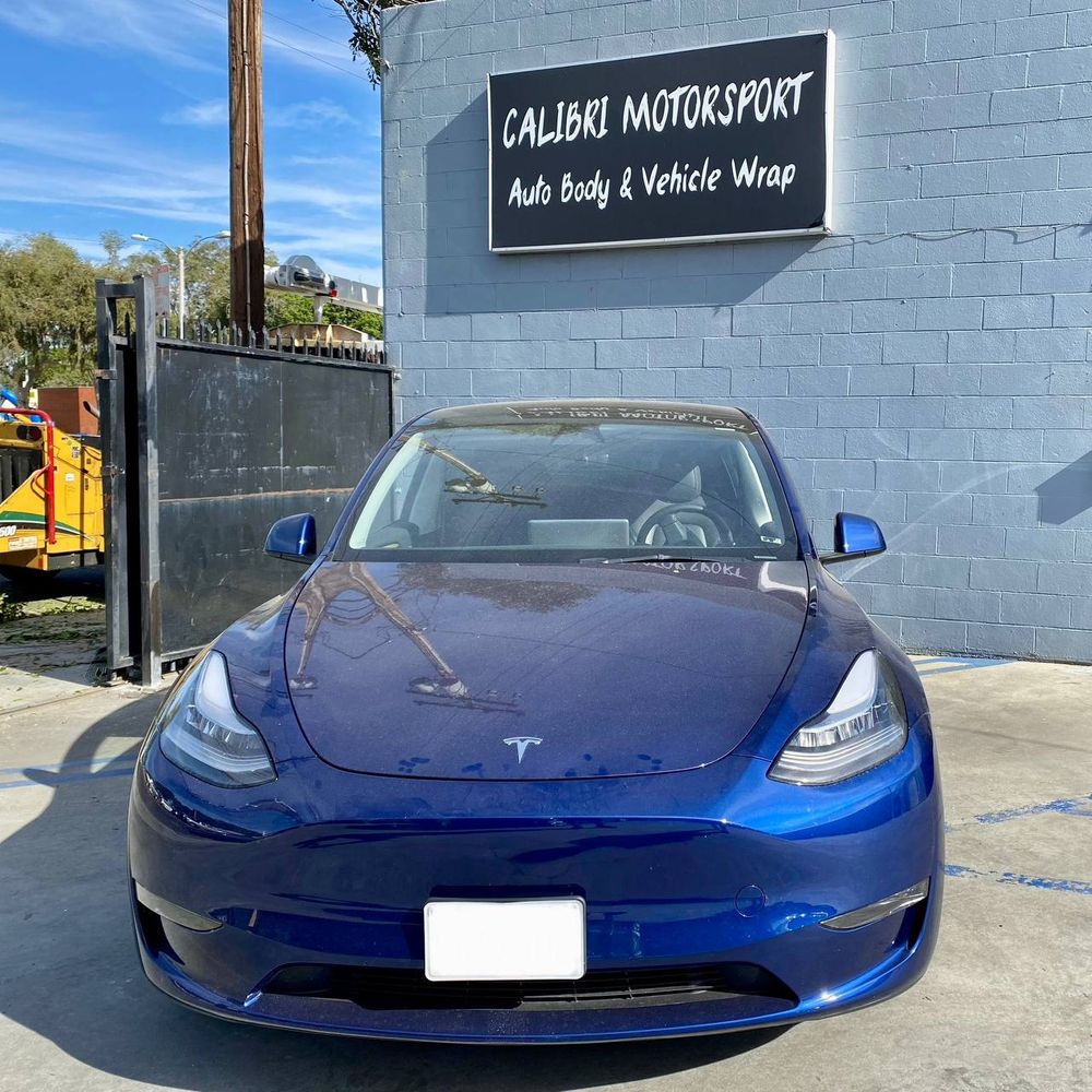 Blue Tesla Model Y photographed at Calibri Motorsport