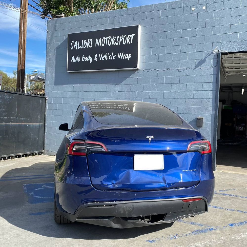 Rear collision damage on a blue Tesla Model Y
