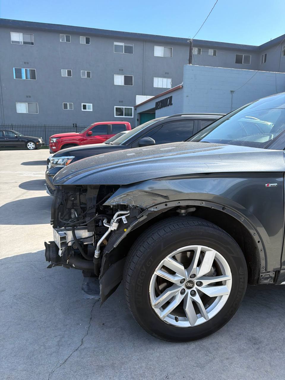 Close side view of the exposed left-front corner of an Audi Q5 after a collision