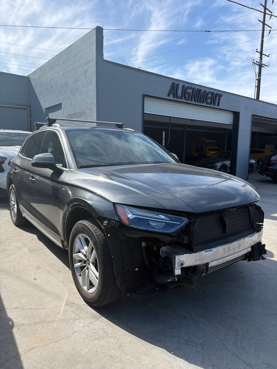 Audi Q5 with its front bumper removed during collision intake at Calibri Motorsport in Hawthorne
