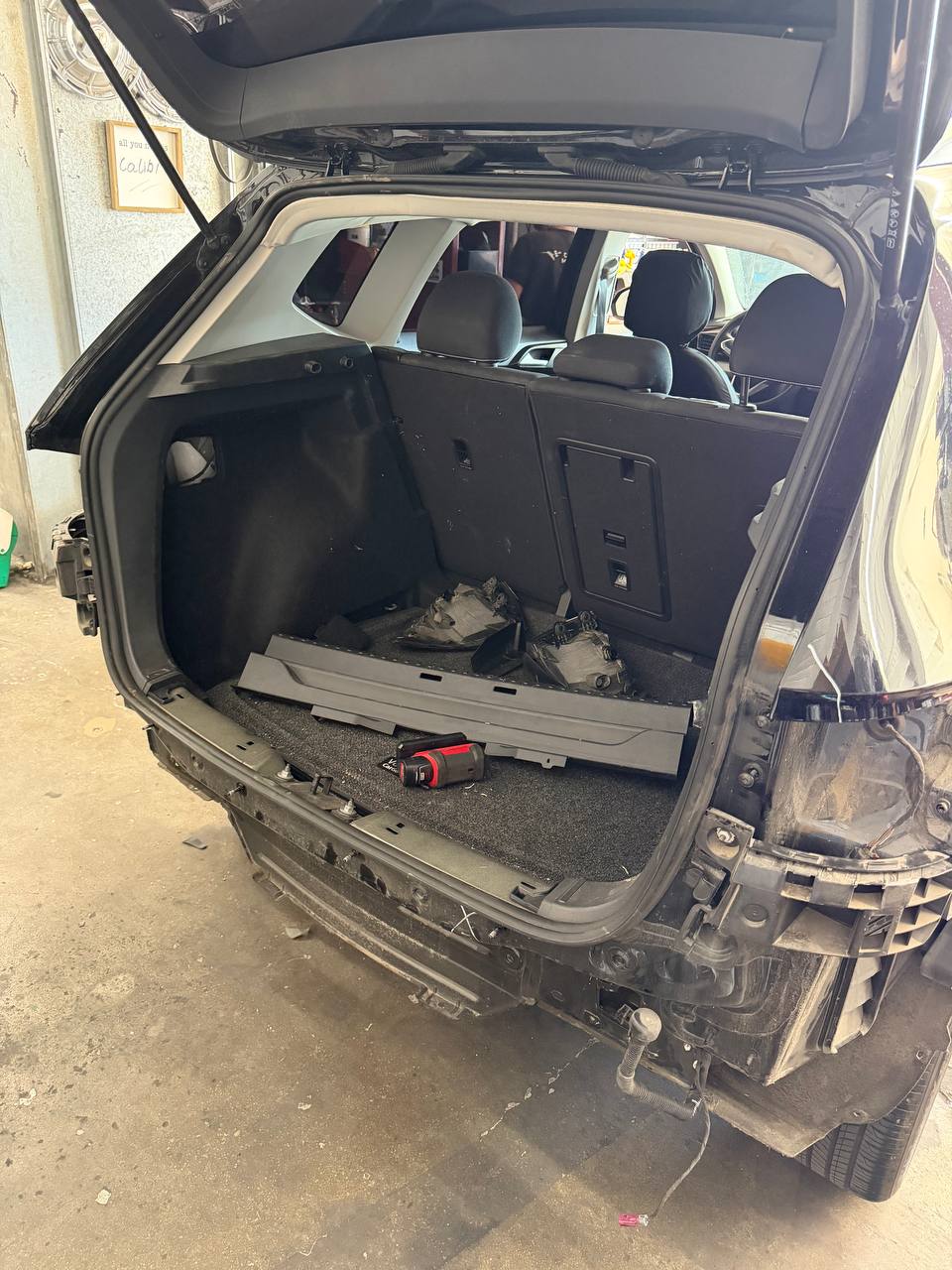 Open cargo area of a Volkswagen Taos during rear collision teardown