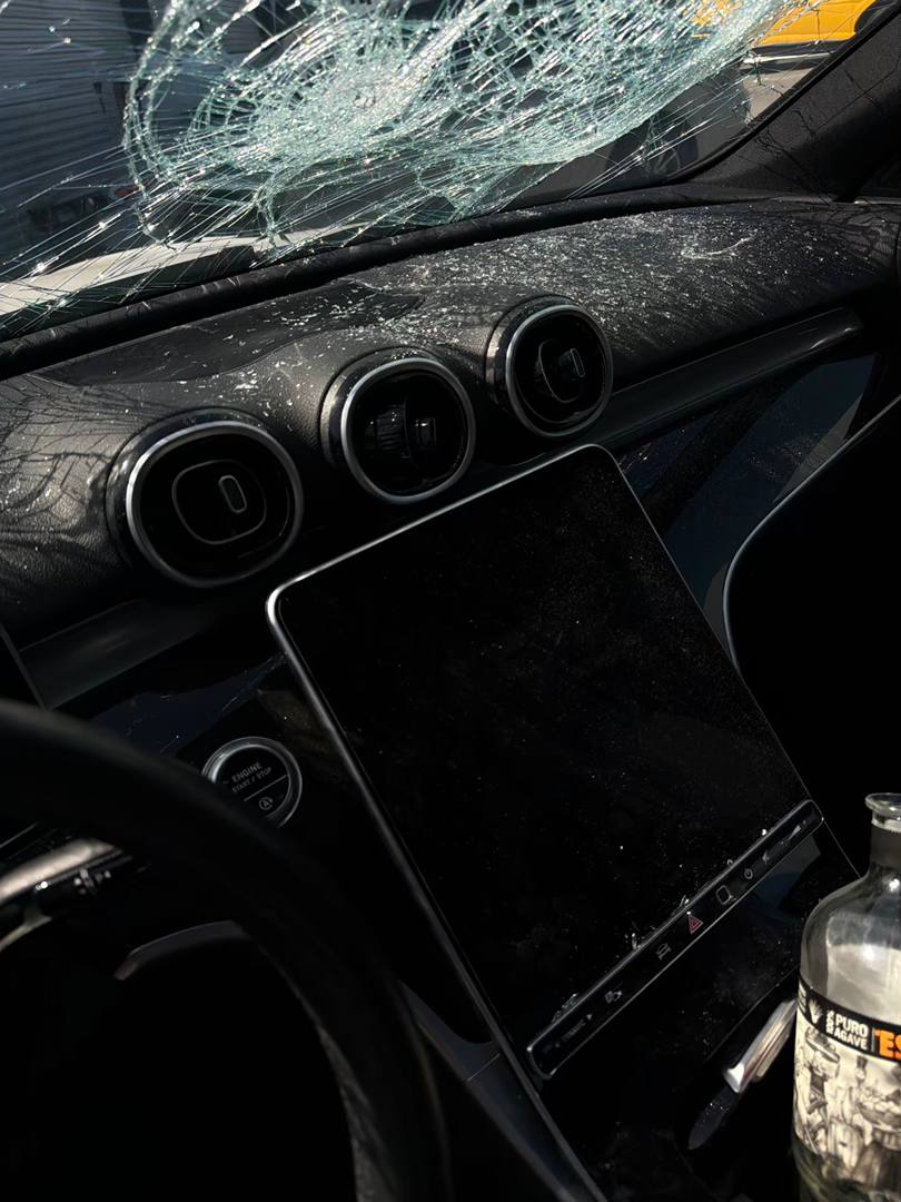 Mercedes-Benz C300 dashboard beneath a severely cracked windshield
