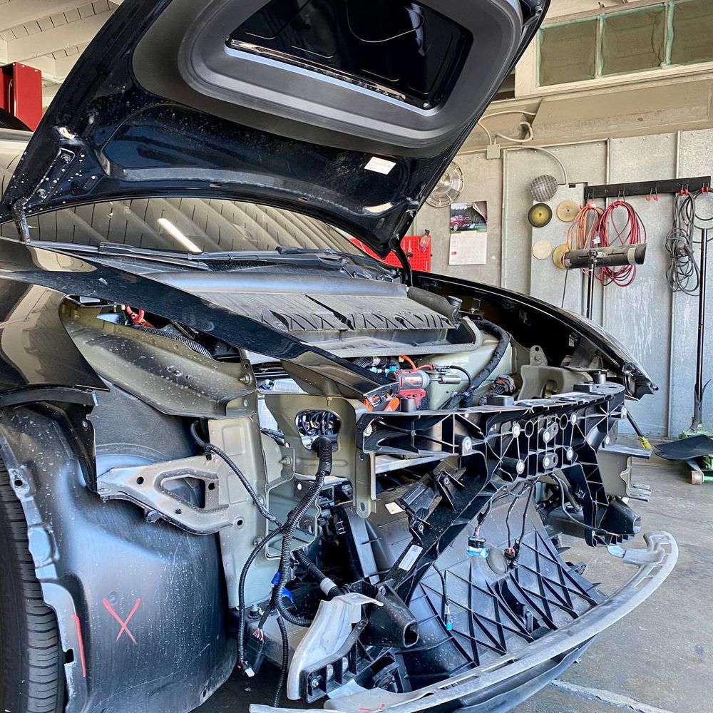 Tesla with front exterior components removed during collision work