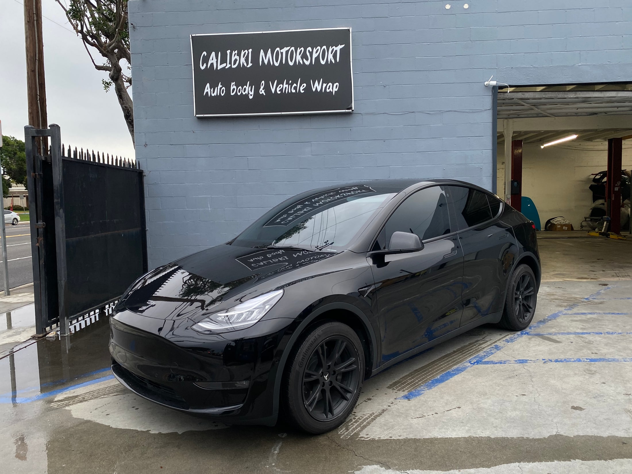 Black Tesla Model Y outside Calibri Motorsport in Hawthorne