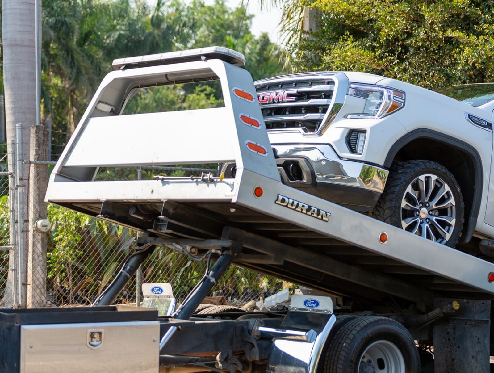 Vehicle being loaded onto a flatbed tow truck