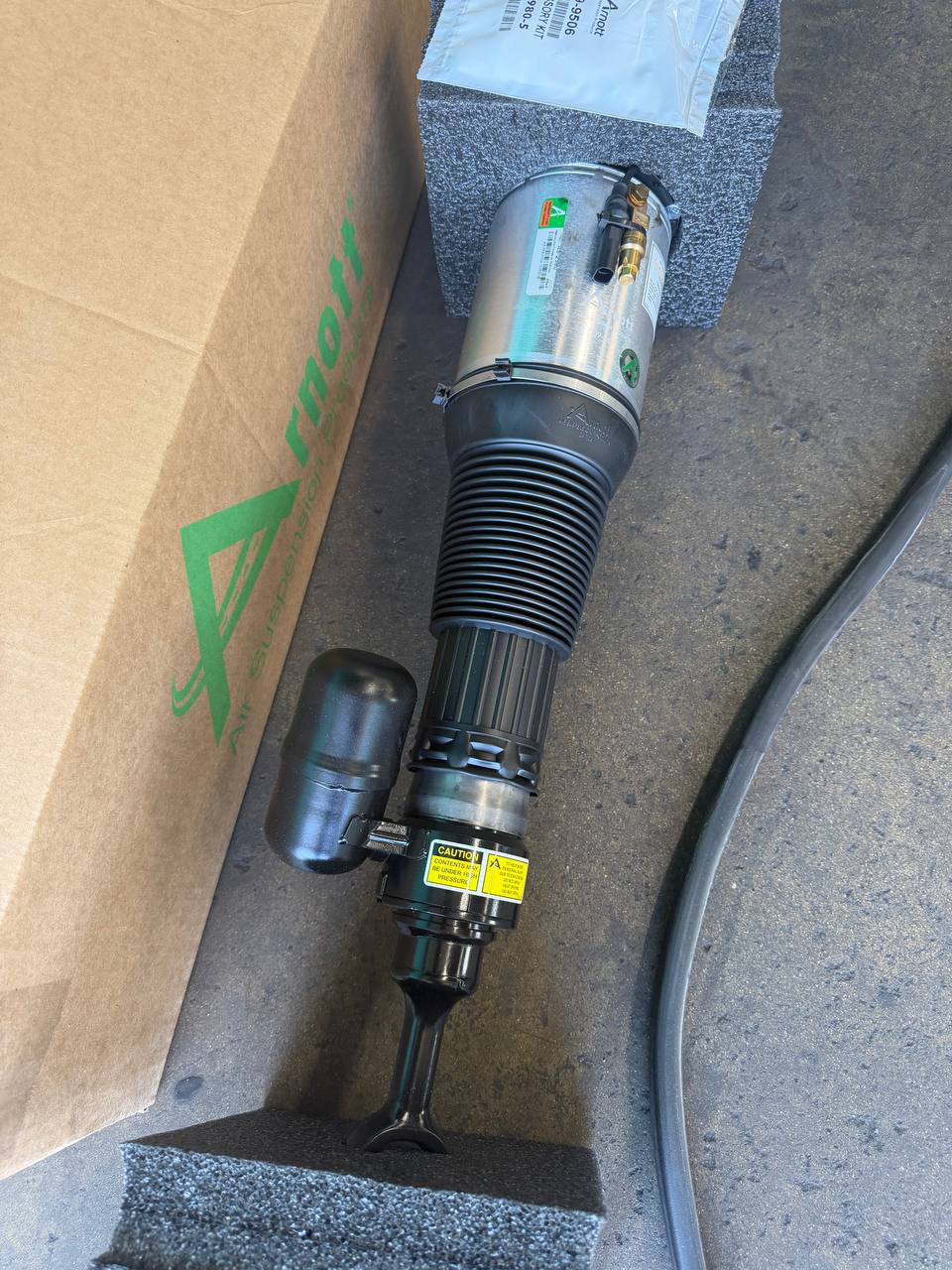 Replacement air strut prepared for a Bentley suspension repair