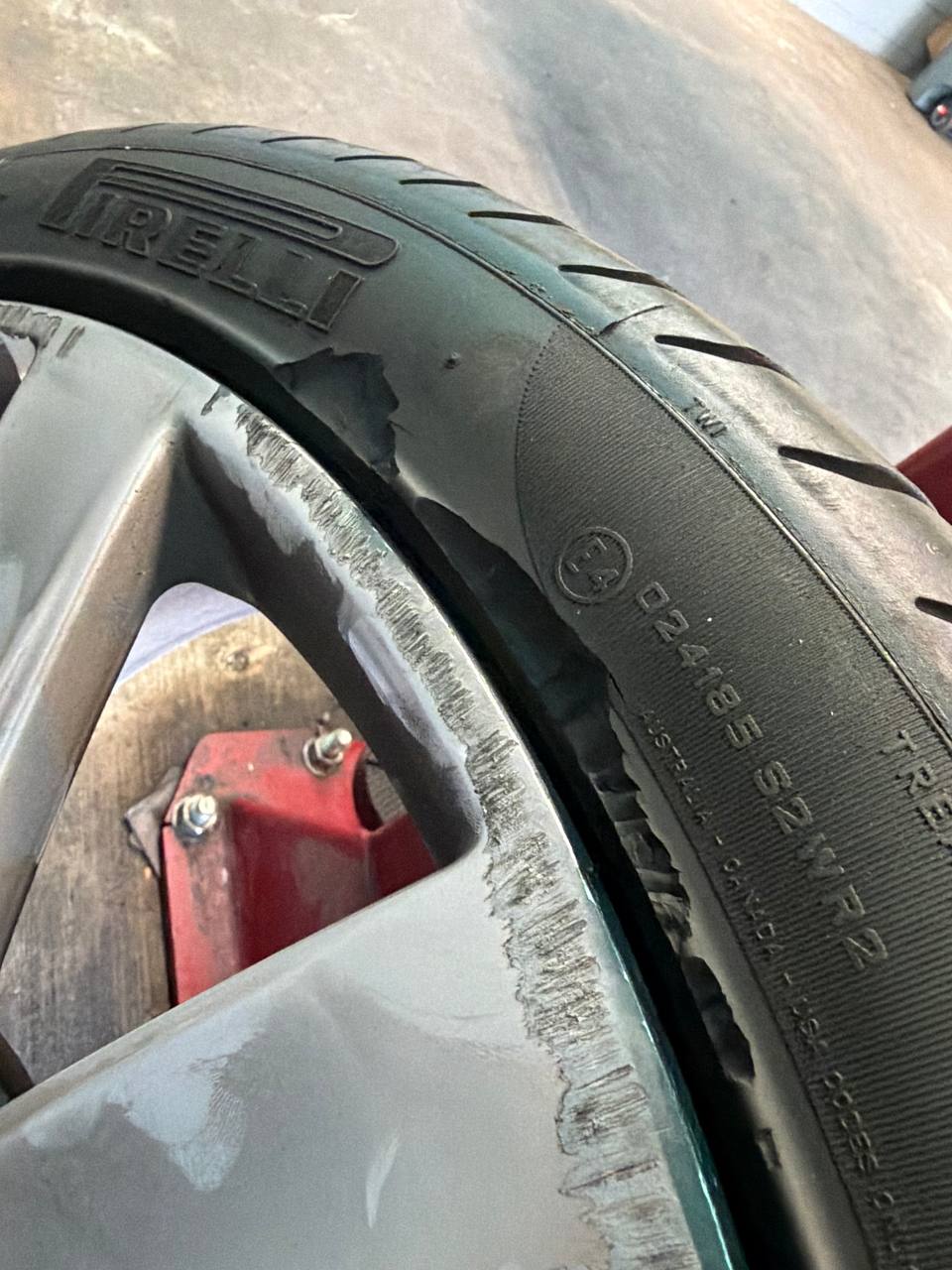 Close-up of curb damage on a Bentley alloy wheel