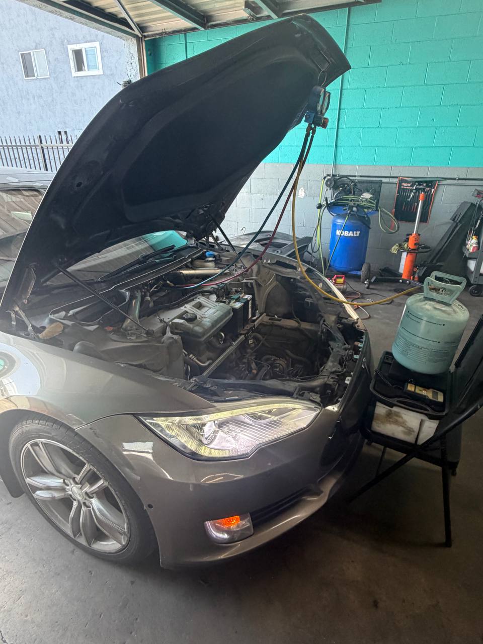 Tesla Model S with the front compartment open during air-conditioning service