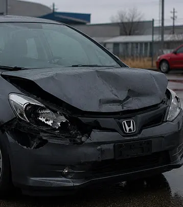 Honda with visible front collision damage in a supplied before photograph