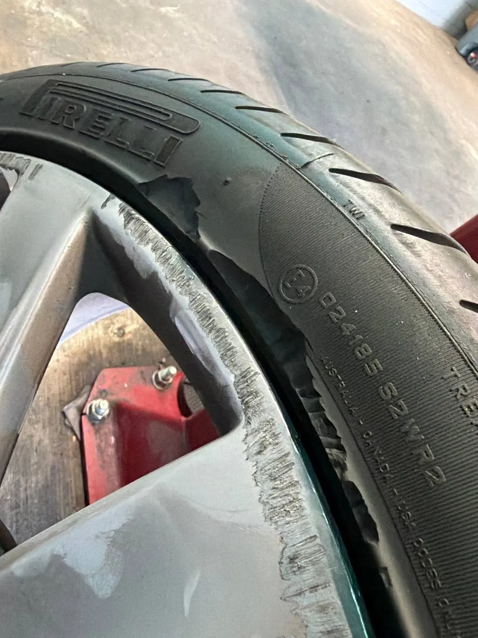 Close-up of curb damage on a Bentley alloy wheel
