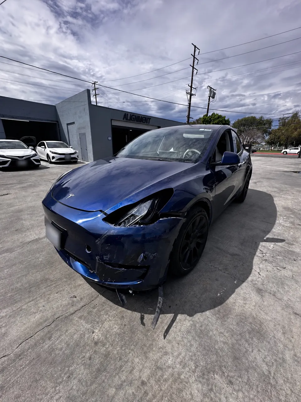 Tesla Model Y with visible front collision damage at Calibri Motorsport