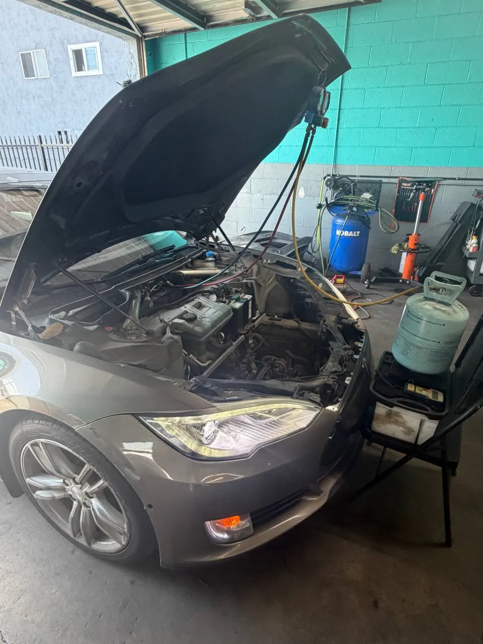 Tesla Model S with the front compartment open during air-conditioning service