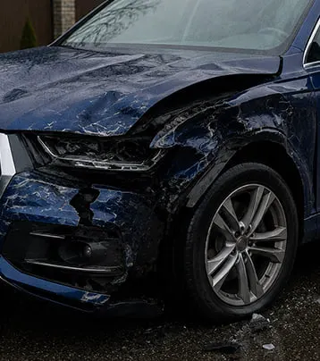 Audi with visible front-left collision damage in a supplied before photograph