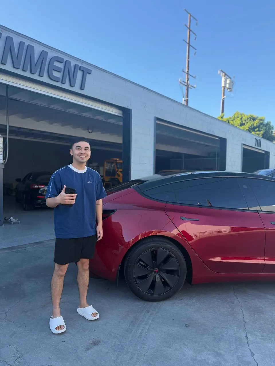 Customer beside the finished red Tesla Model 3 at Calibri Motorsport
