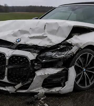 BMW with visible front collision damage in a supplied before photograph