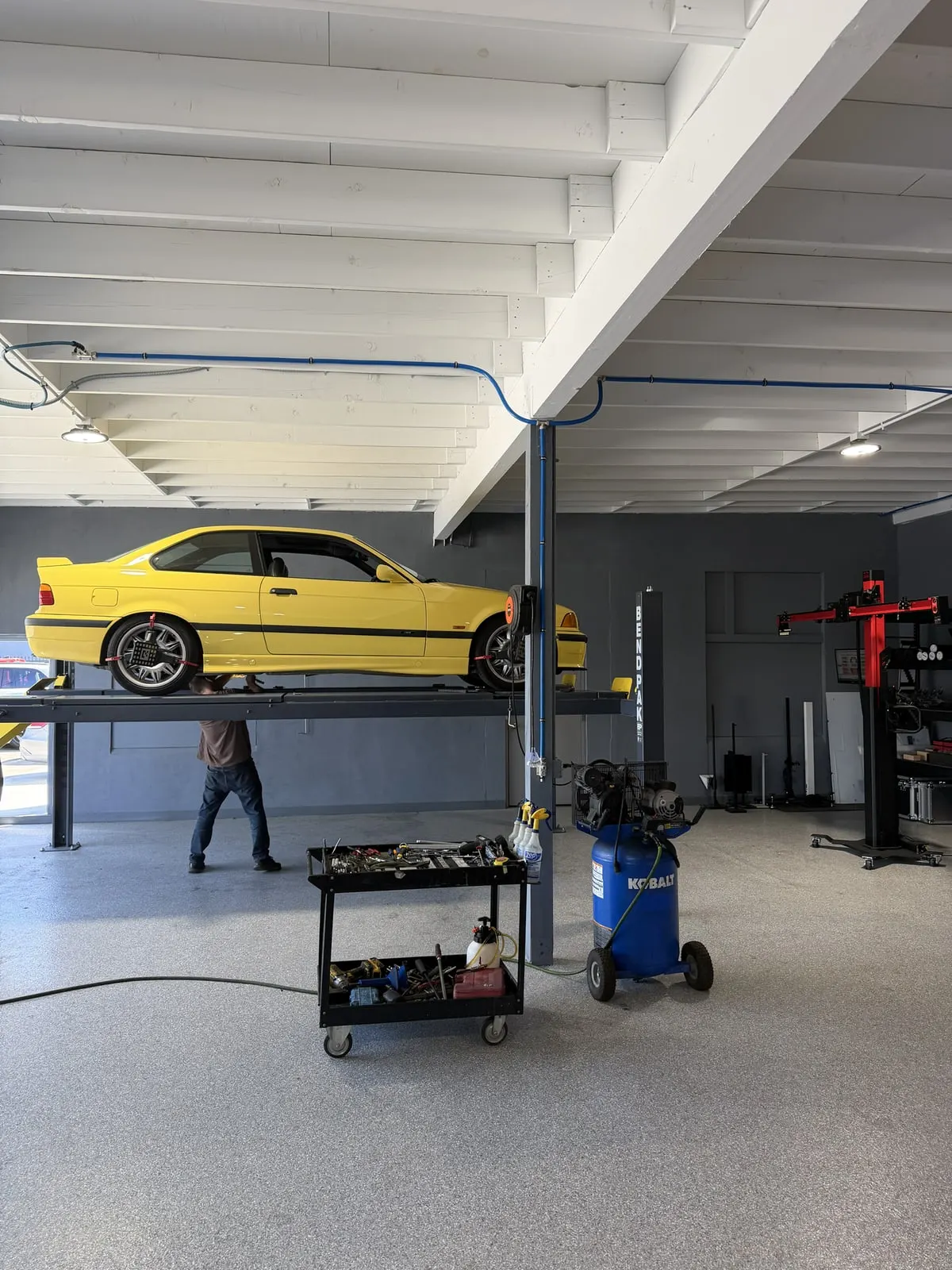 BMW on a lift in the Calibri Motorsport mechanical service bay
