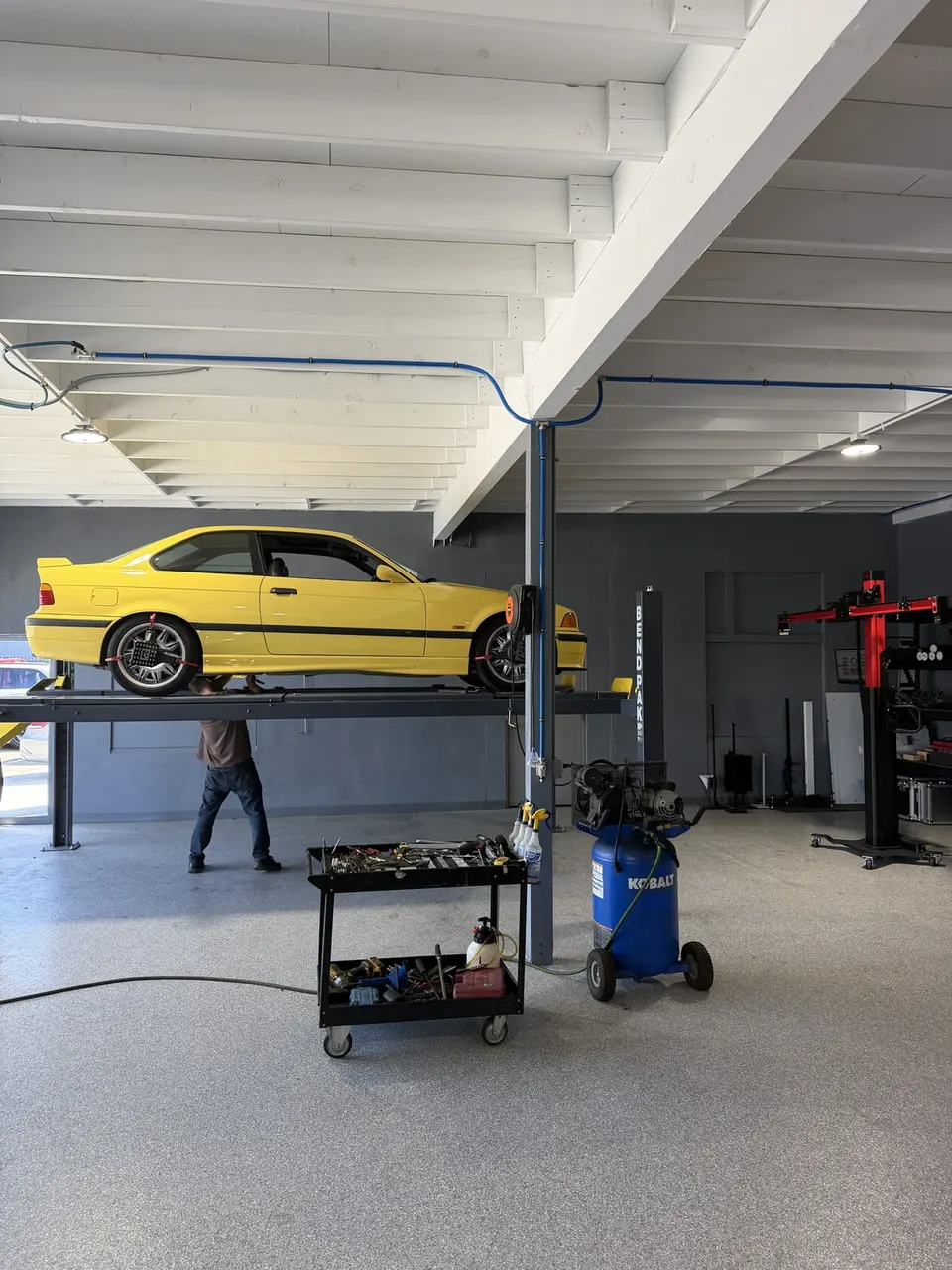 BMW on a lift in the Calibri Motorsport mechanical service bay