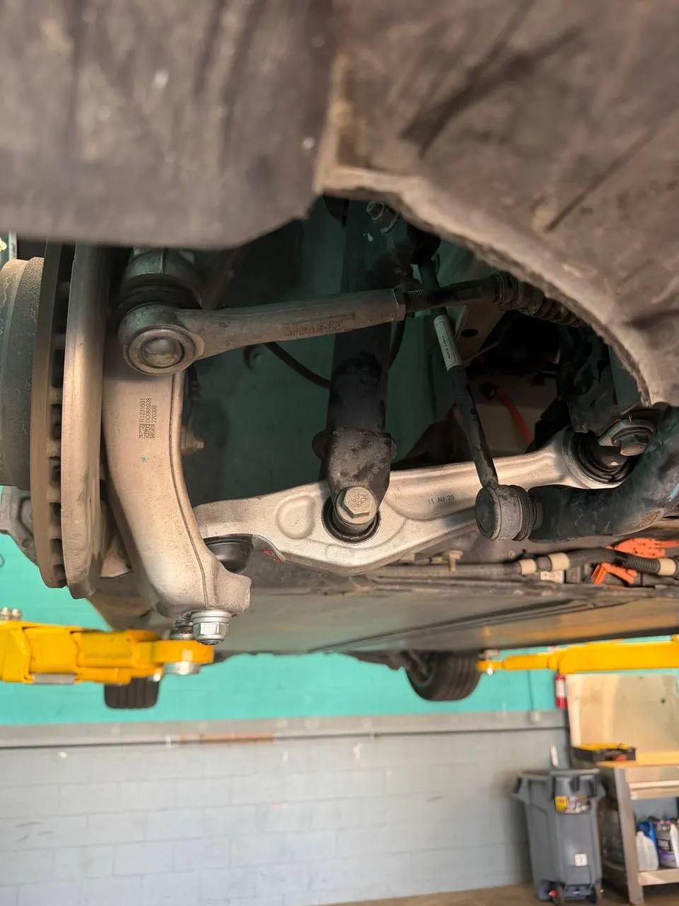 Assembled Tesla Model 3 control-arm and front suspension area after repair