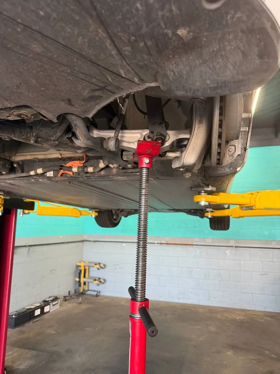 Tesla Model 3 suspension supported during control-arm installation