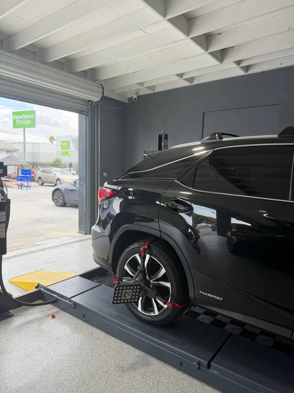 Lexus Hybrid rear wheel with an alignment target on the workshop rack