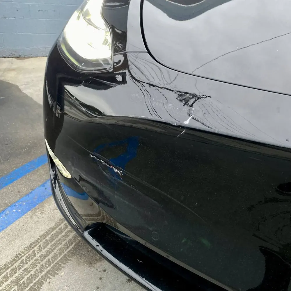 Visible front collision damage on a Tesla Model Y documented at Calibri Motorsport in Hawthorne