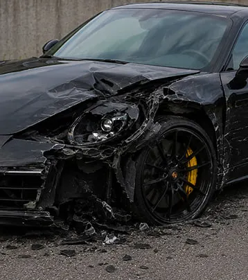 Porsche with visible front-left collision damage in a supplied before photograph