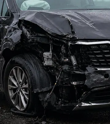 Kia with visible front-left collision damage in a supplied before photograph