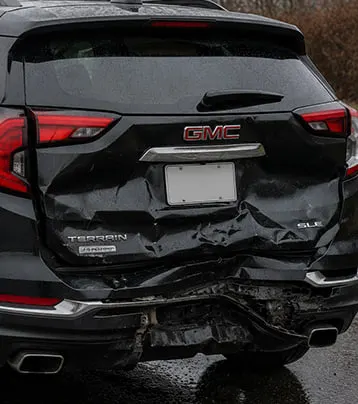 GMC with visible rear collision damage in a supplied before photograph