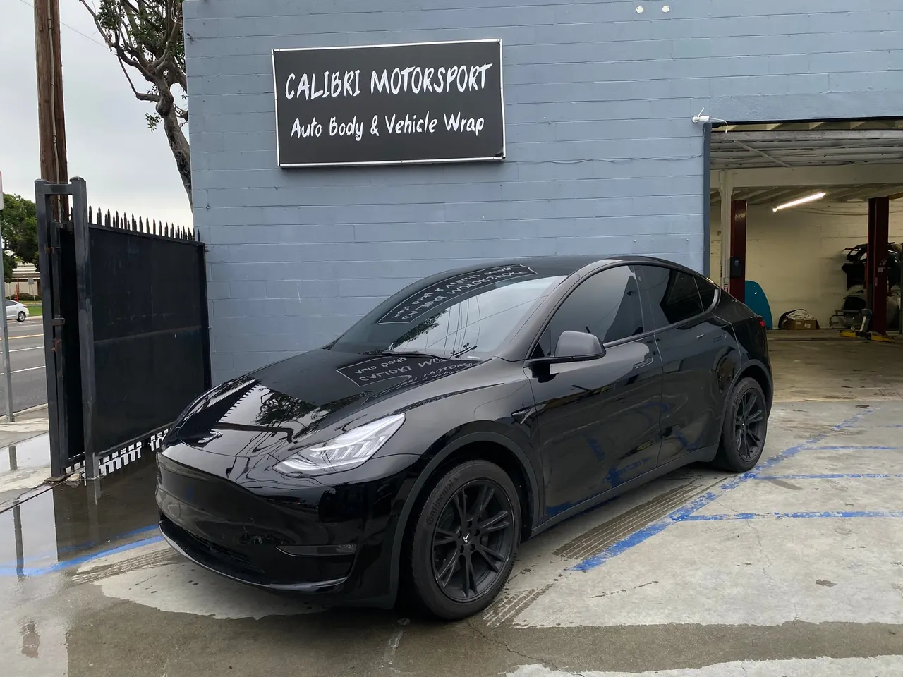Black Tesla Model Y outside Calibri Motorsport